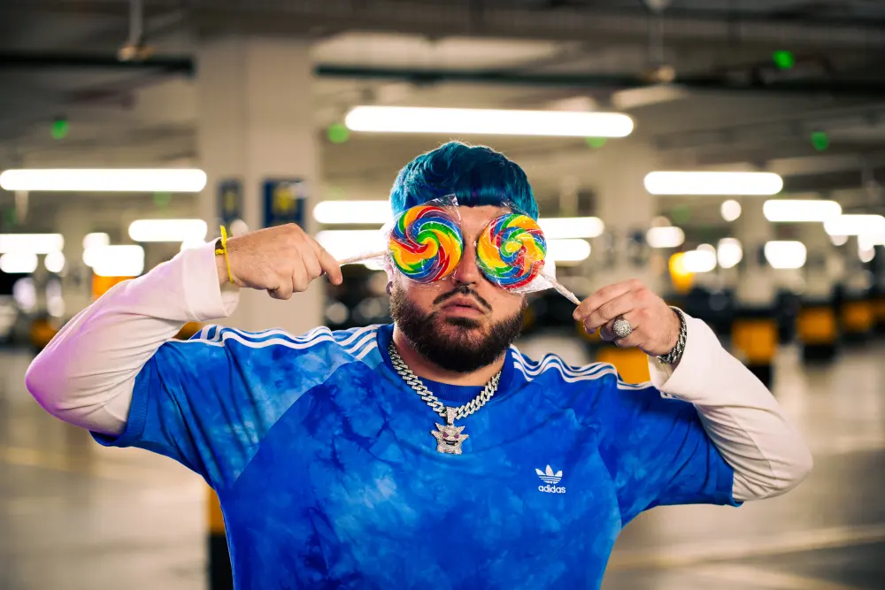Artista com pirulitos diante dos olhos durante a produção de um videoclipe.